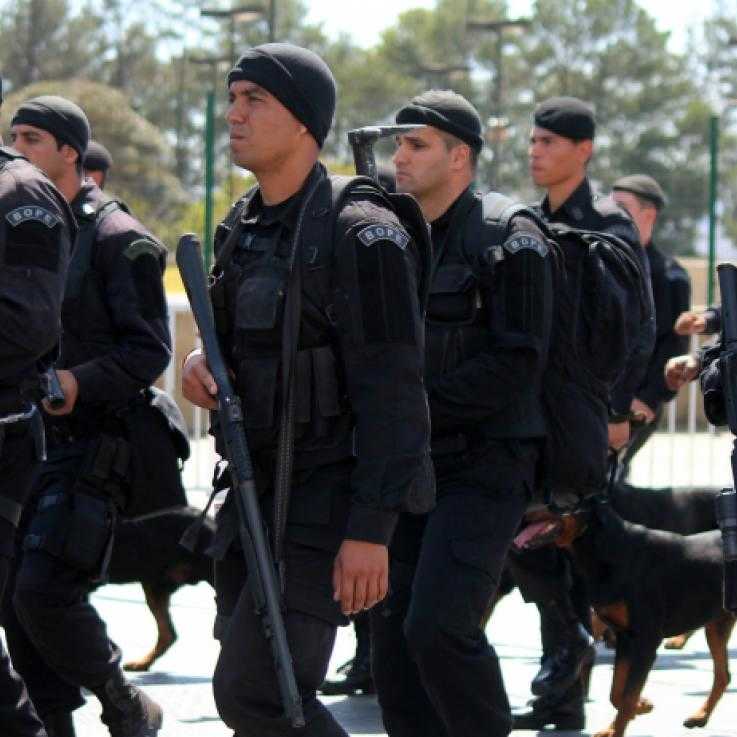 Several black-clad and heavily armed police officers