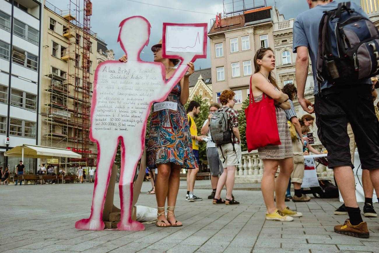 Activists in Brno display signs shaped like people with information about the Czech arms trade