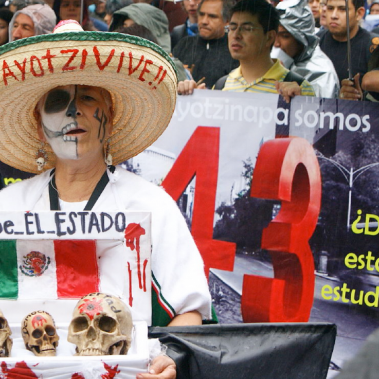 A woman with her face painted as a skeleton takes part in a protest in Mexico, remembering the 43 Mexican students killed